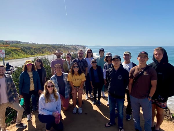 a group photo from a vantage point looking down upon dip in the road. 