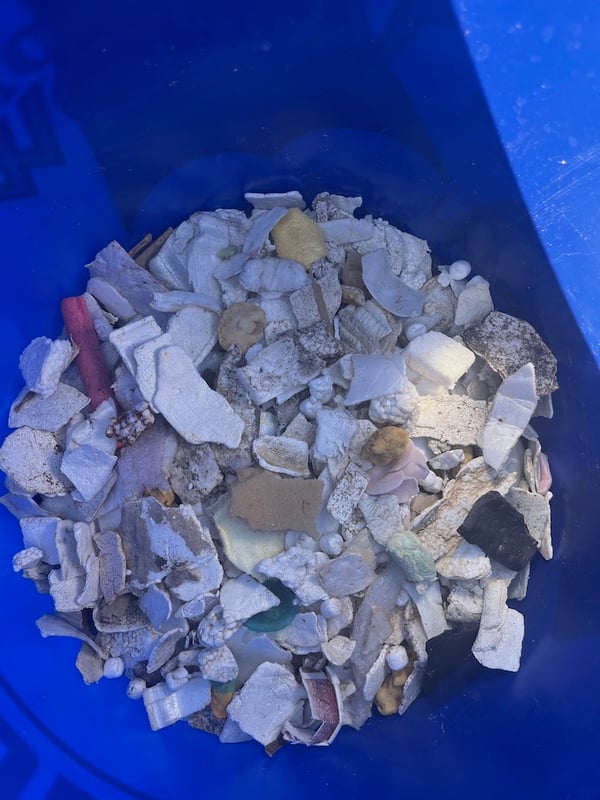 A bucket full of foam pieces from a beach in Oceanside